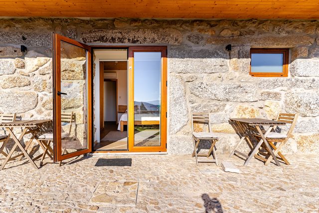 Rustic stone patio with mountain view at Casa do Sol, Celorico de Basto