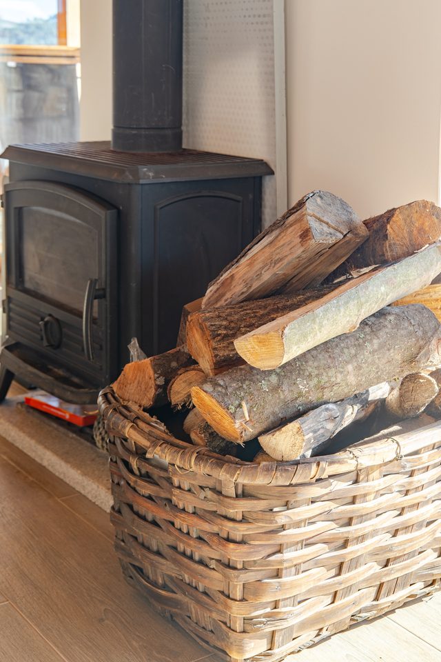 Firewood basket and fireplace at Casa do Sol rural villa, Portugal