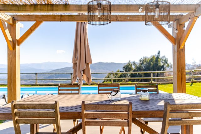 Poolside dining terrace with mountain views at Casa do Sol, Northern Portugal