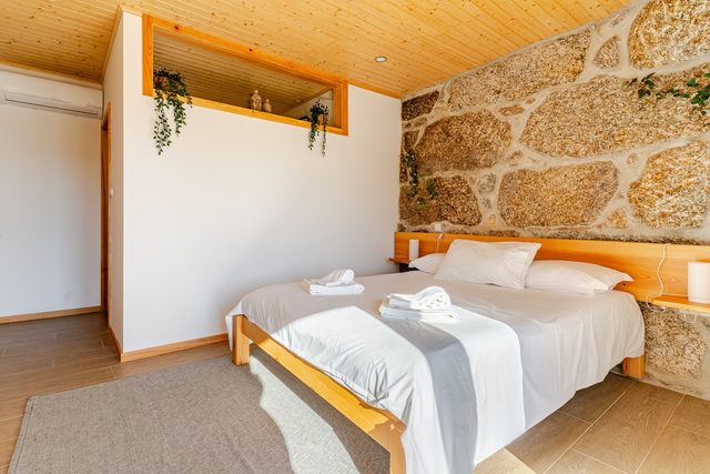 Rustic stone barn bedroom at Casa do Sol, Northern Portugal